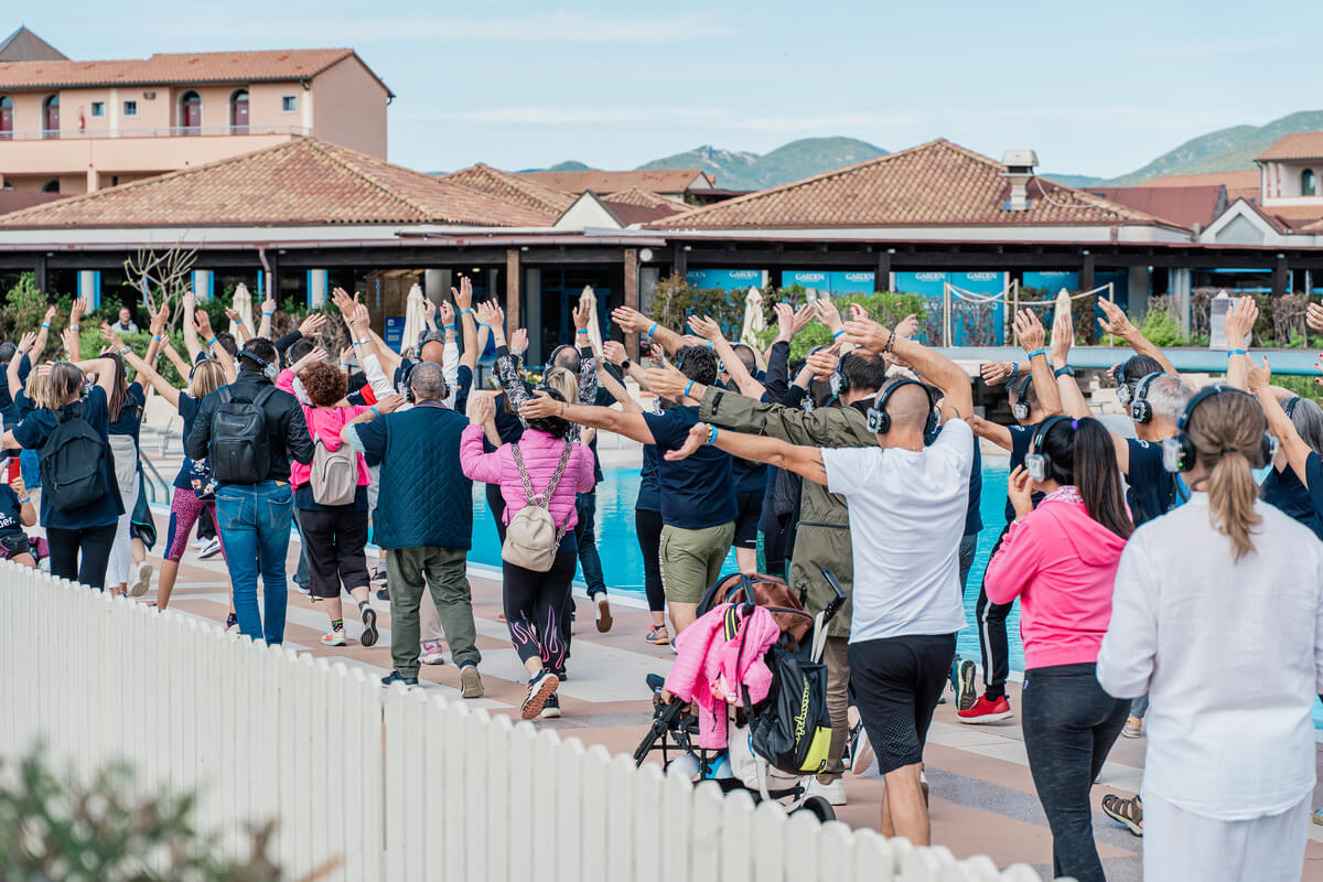 persone che fanno attività fisica in gruppo intorno la piscina